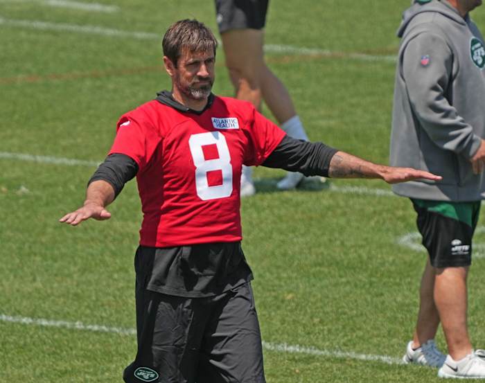 QB Aaron Rodgers gestures during a Jets' OTAs practice